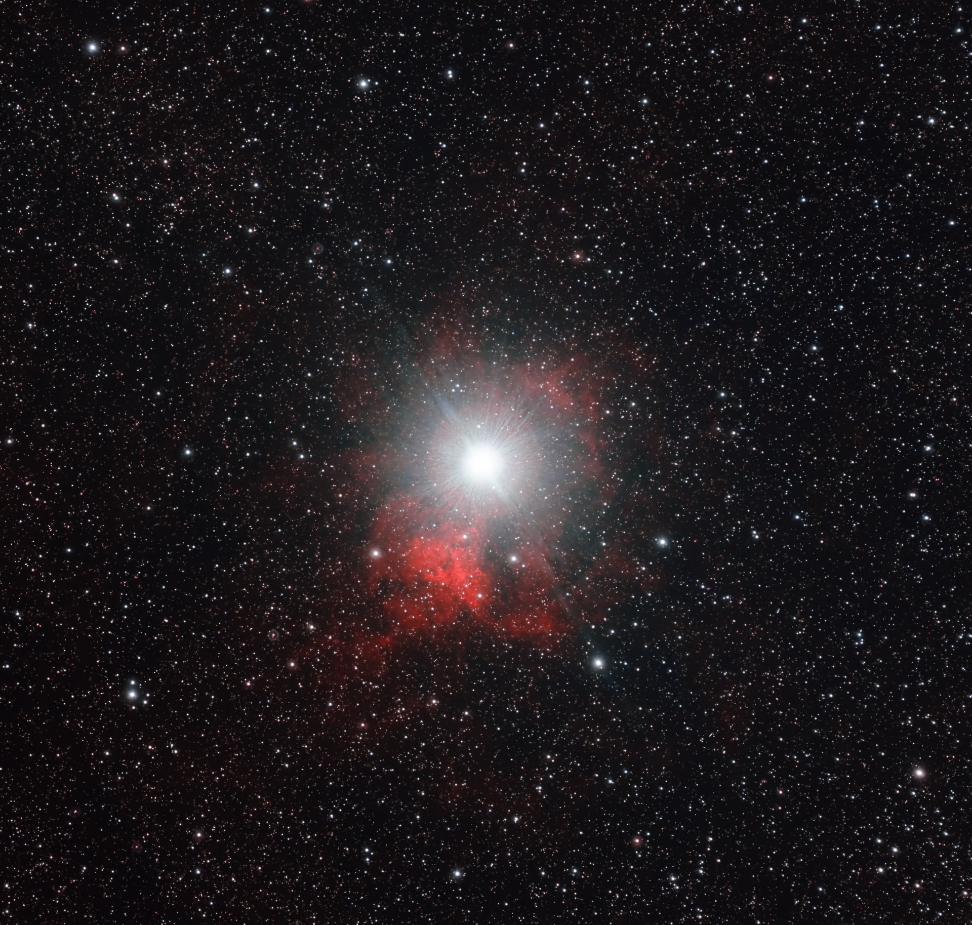 A red emission complex surrounding a brilliant star in the Ghost of Hadar region.