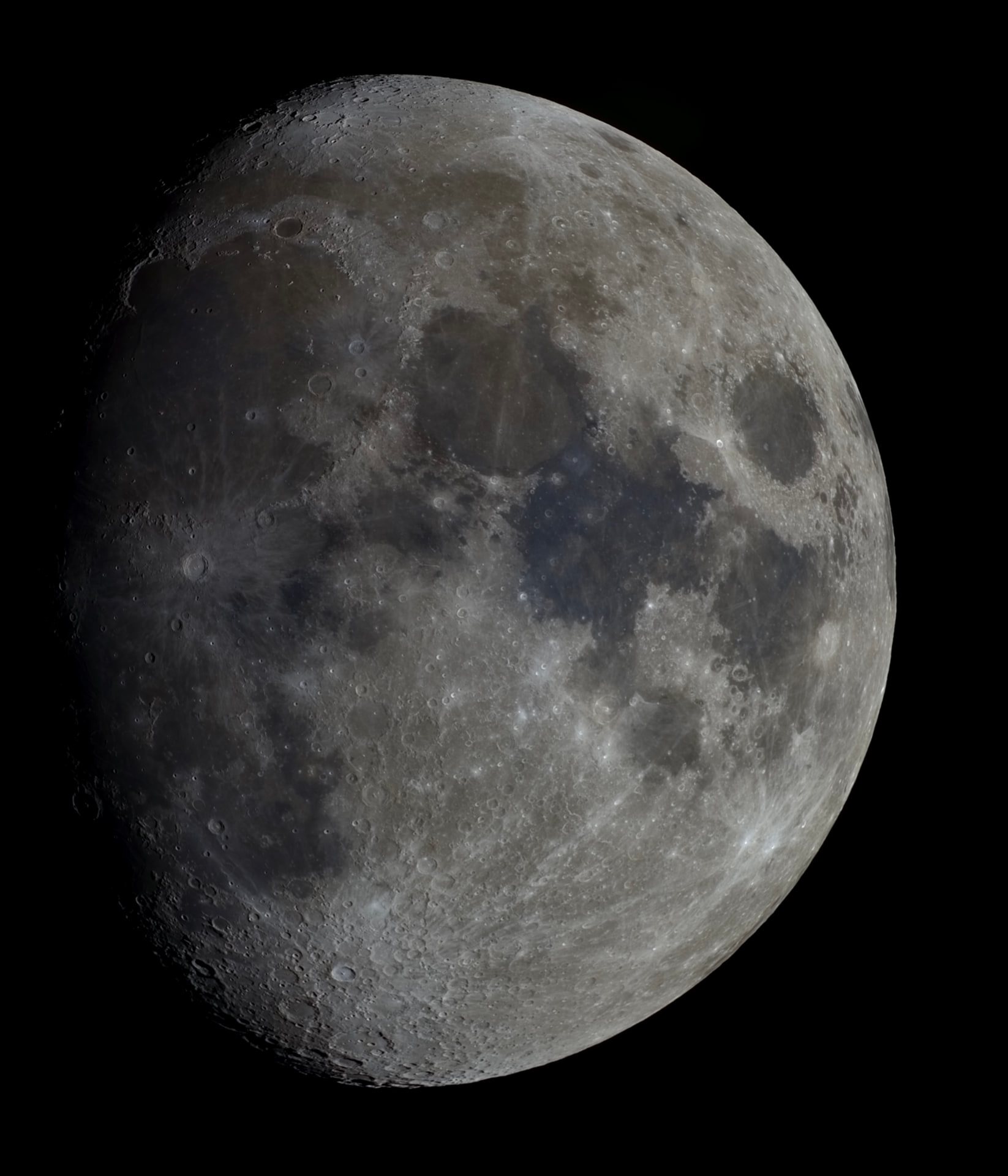 A detailed waxing Moon showing cratered highlands and broad dark lunar maria.