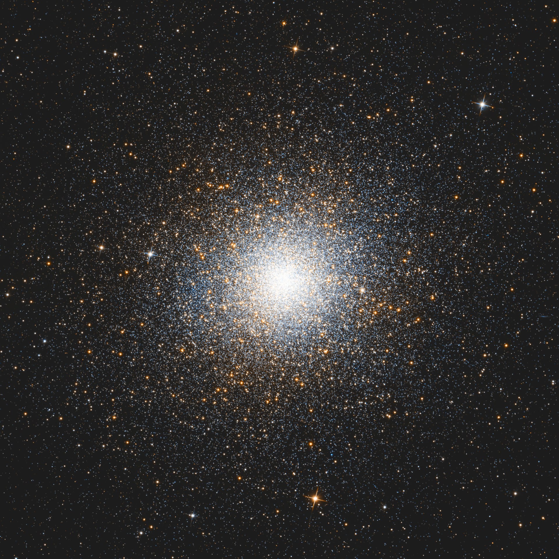 Omega Centauri forming a densely packed sphere of warm stars on a dark background.